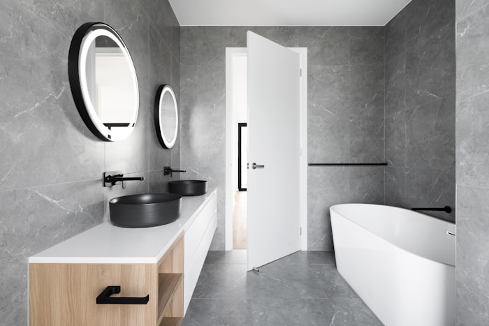 Detail of premium stone tile and gold fixtures in luxury bathroom